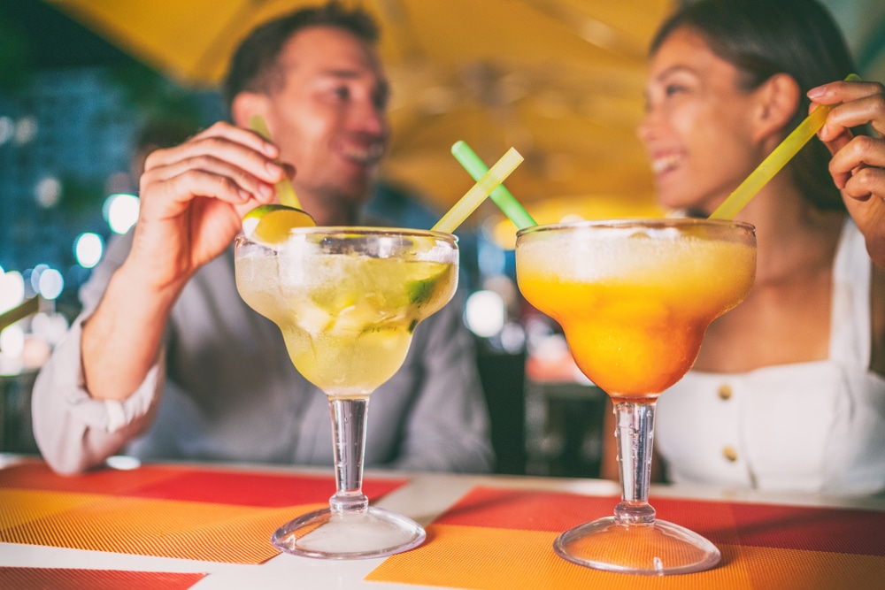 Restaurants in St. Augustine, couple enjoying a tropical drink at a bar in St. Augustine