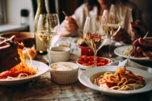 Wine glasses and dishes as friends enjoy a meal at one of the best St. Augustine Restaurants