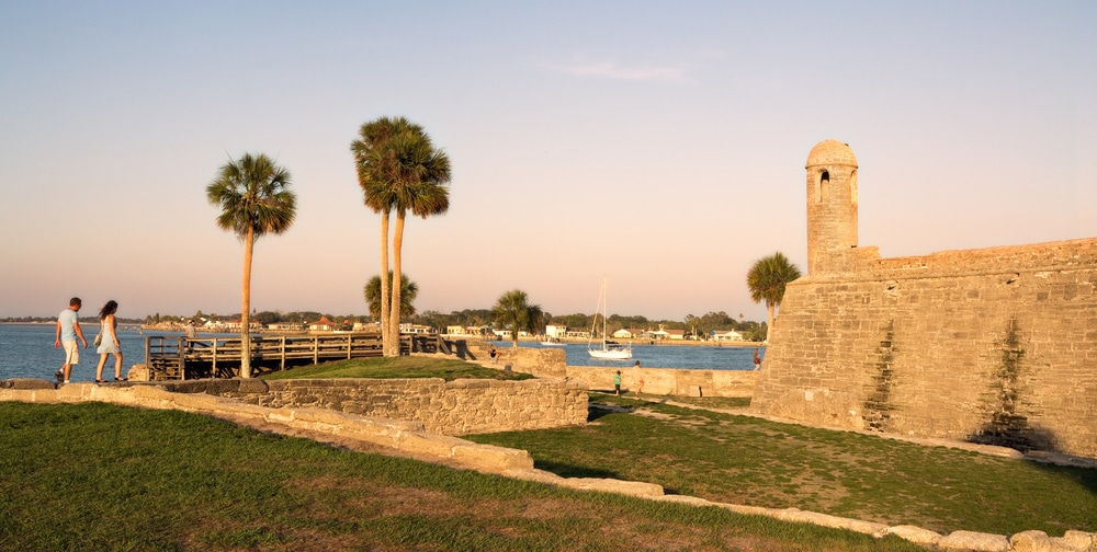 Couple walking at Castillo de San Marcos and enjoying the top romantic things to do in St. Augustine