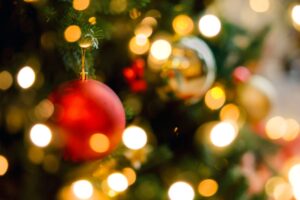 Enjoy a St. Augustine Christmas this year! Close up of a Christmas tree and bulbs creates a festive atmosphere.