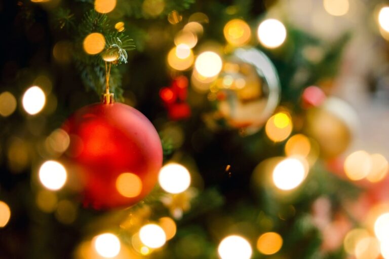 Enjoy a St. Augustine Christmas this year! Close up of a Christmas tree and bulbs creates a festive atmosphere.